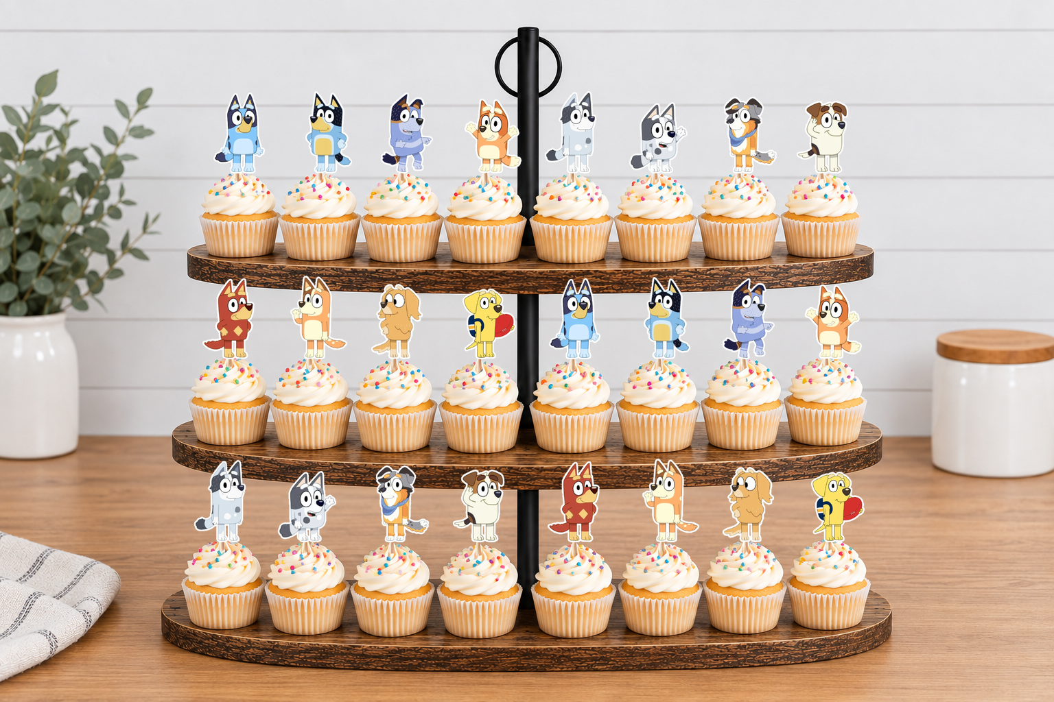 Character cupcake toppers arranged on a three-tier cupcake stand